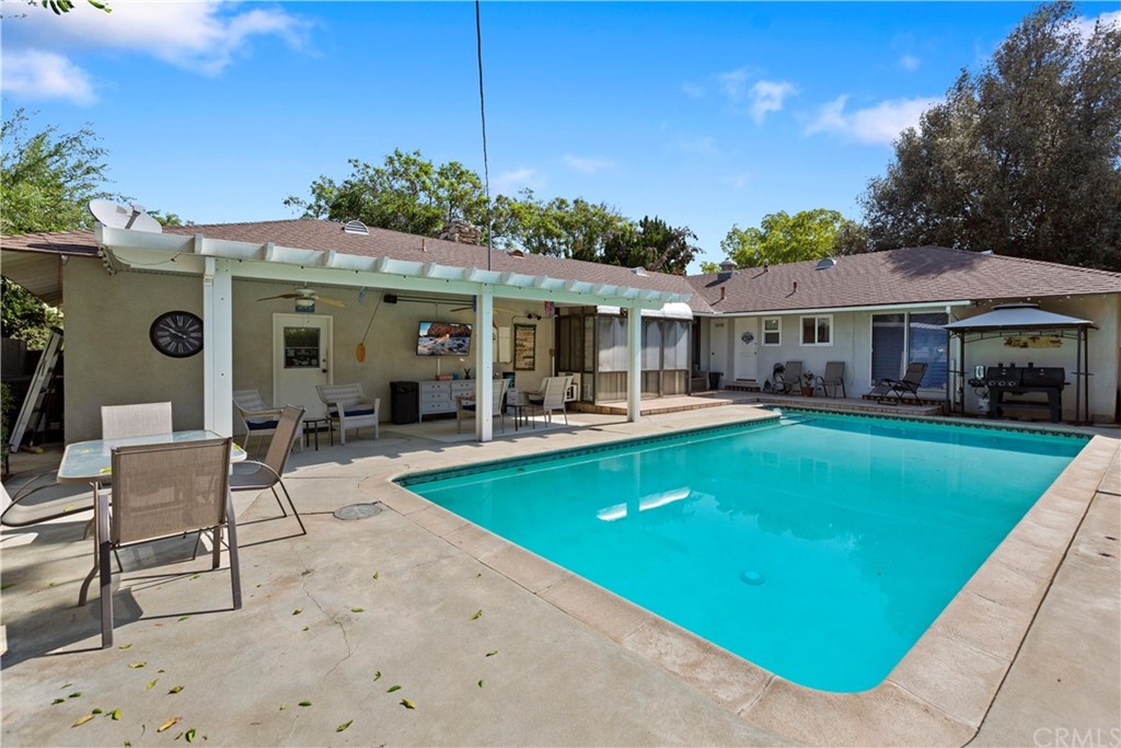 5201 Coventry Drive Riverside, CA 92506 - Photo 30 of 42 a view of a house with swimming pool lawn chairs and a yard