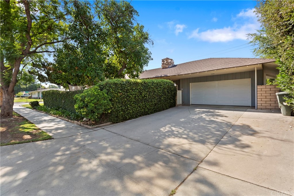 5201 Coventry Drive Riverside, CA 92506 - Photo 7 of 42 a front view of a house with a yard and garage
