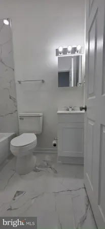 a bathroom with a toilet and a bath tub