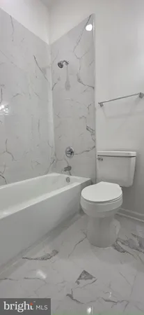 a bathroom with bathtub and shower