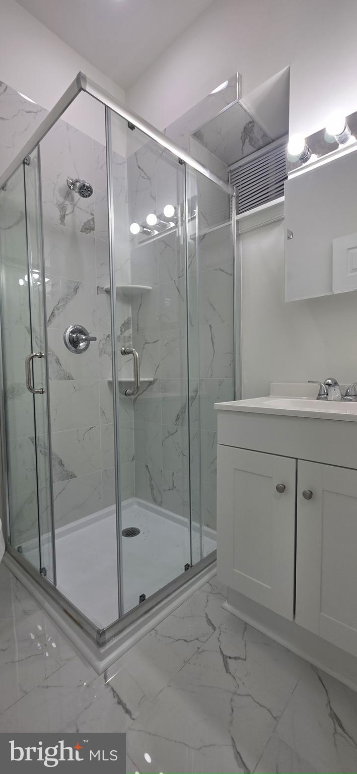 2233 North 16th Street Philadelphia, PA 19132 - Photo 20 of 27 a bathroom with a shower sink and mirror