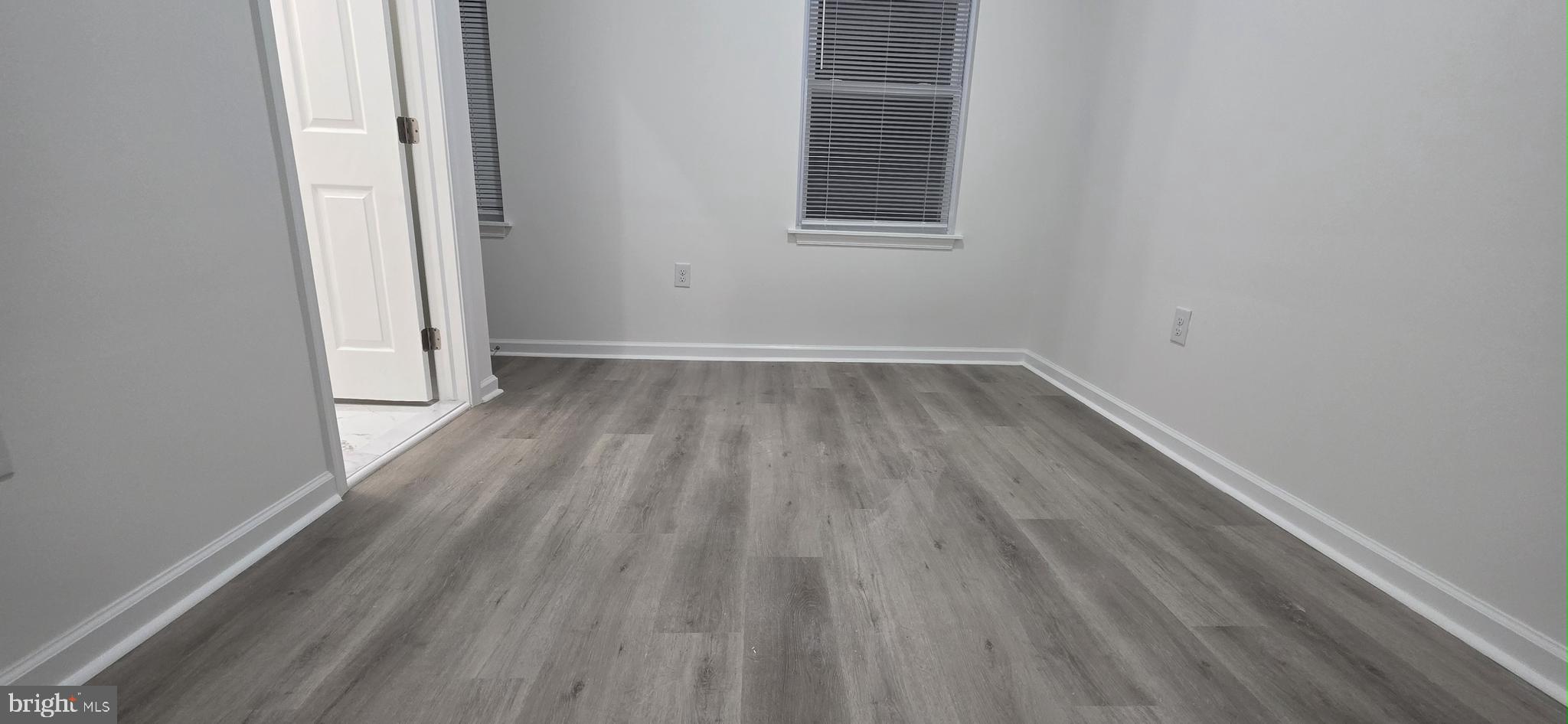 2233 North 16th Street Philadelphia, PA 19132 - Photo 21 of 27 a view of an empty room with wooden floor and a window