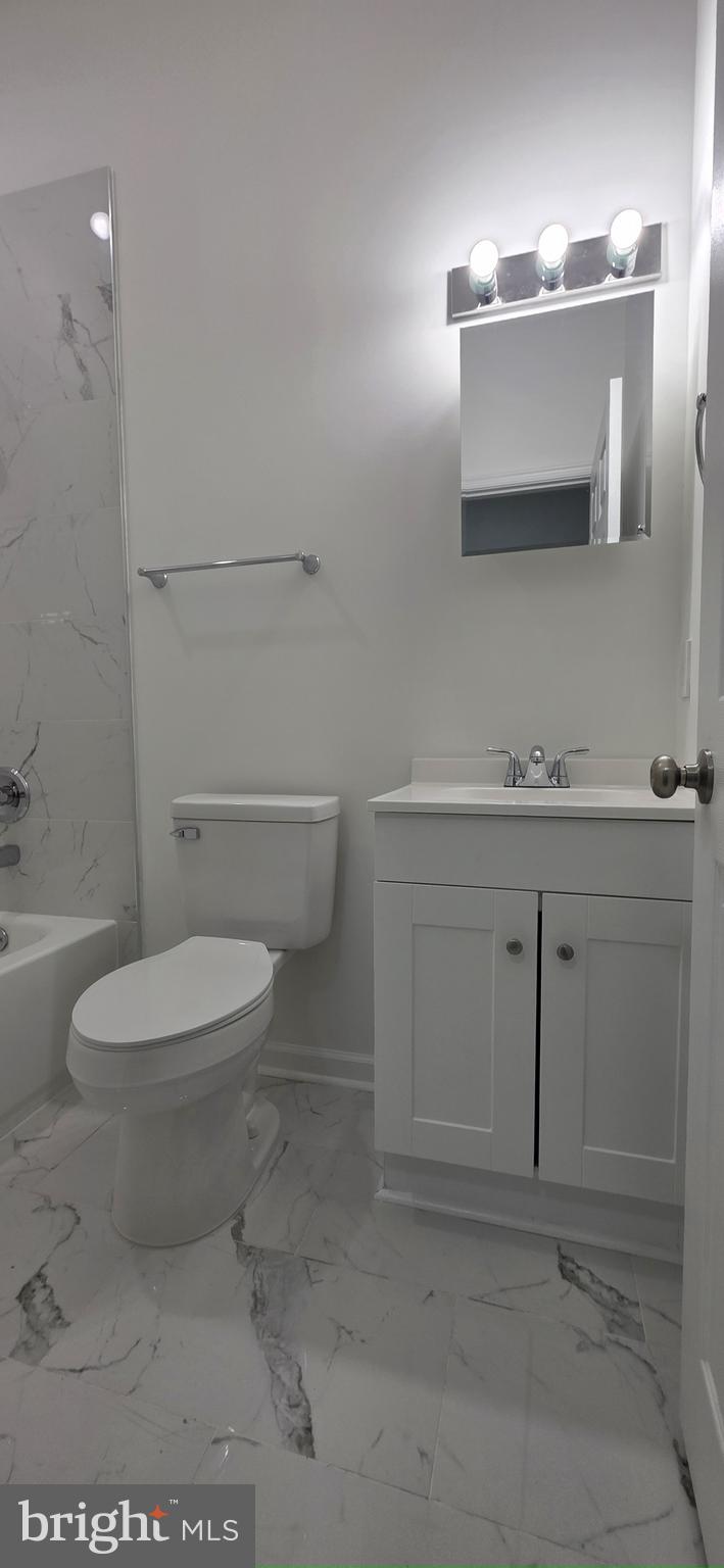 2233 North 16th Street Philadelphia, PA 19132 - Photo 25 of 27 a bathroom with a toilet a sink and mirror