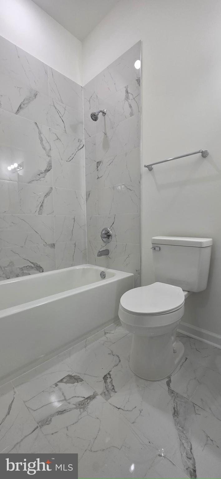 2233 North 16th Street Philadelphia, PA 19132 - Photo 26 of 27 a bathroom with a toilet a sink and a bathtub