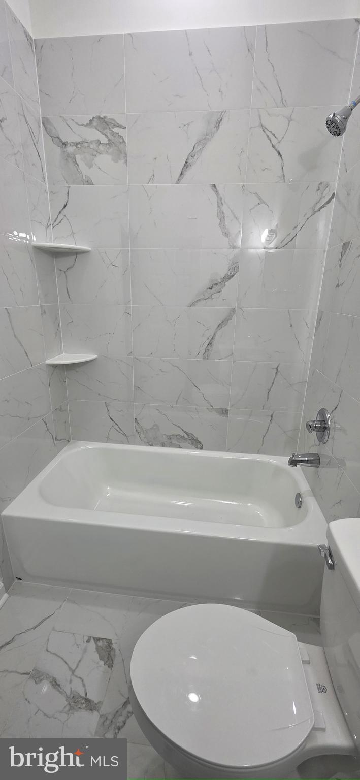 2233 North 16th Street Philadelphia, PA 19132 - Photo 27 of 27 a bathroom with a toilet and bathtub
