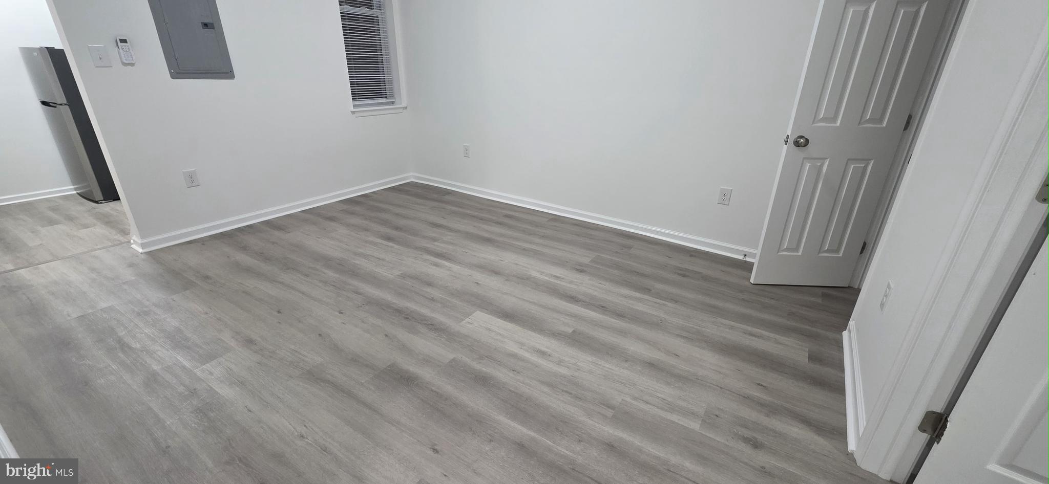 2233 North 16th Street Philadelphia, PA 19132 - Photo 5 of 27 an empty room with wooden floor and entrance