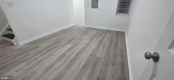 a view of a room with wooden floor and windows