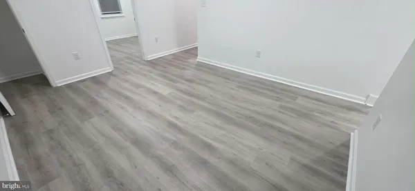 wooden floor in a white room