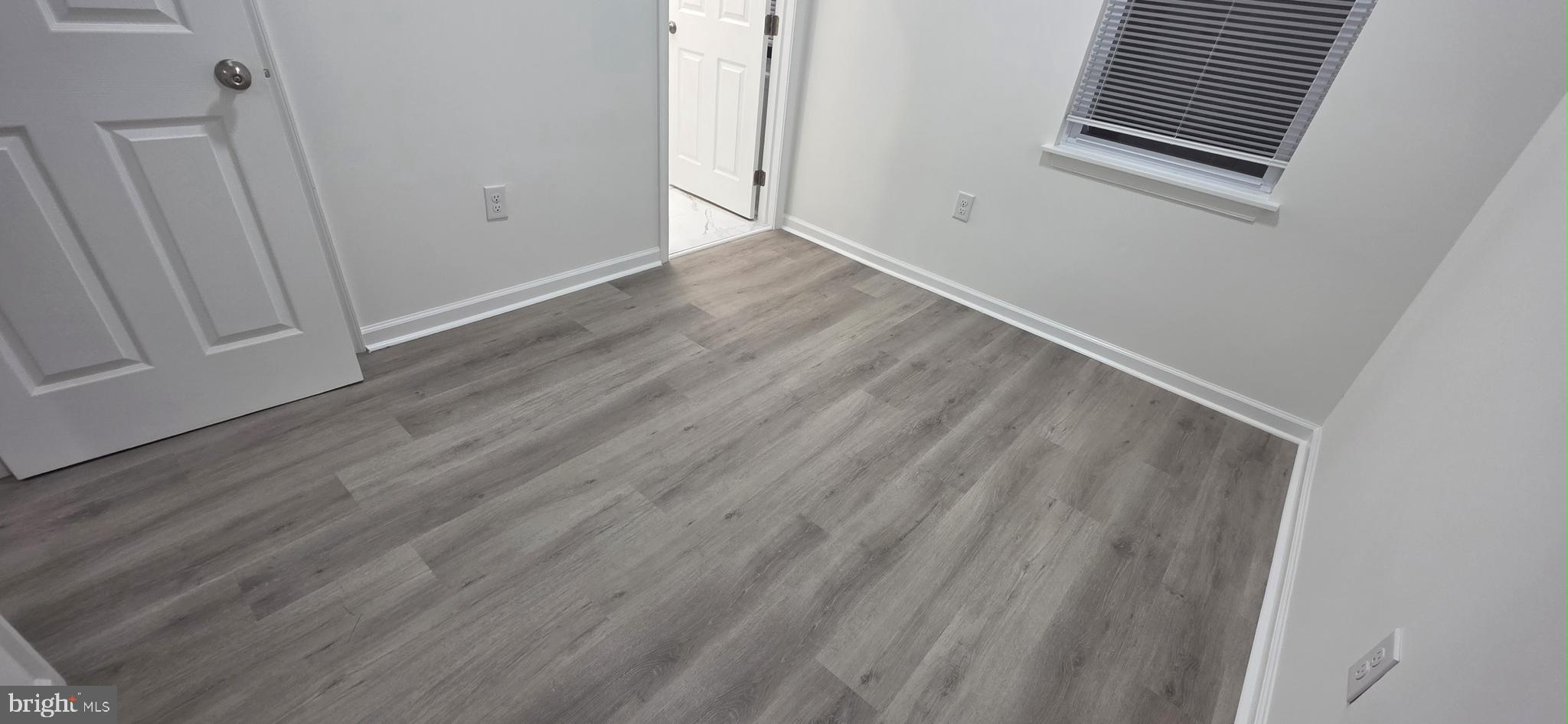 2233 North 16th Street Philadelphia, PA 19132 - Photo 9 of 27 a view of an empty room with wooden floor and a window