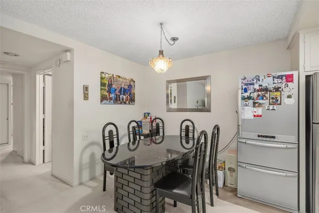 a dining room that has a dining table and chairs