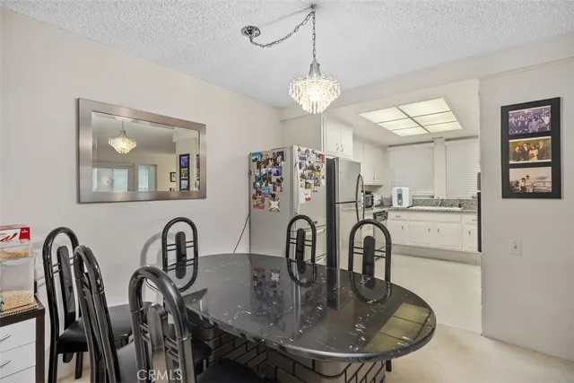 a kitchen with a sink a refrigerator and cabinets