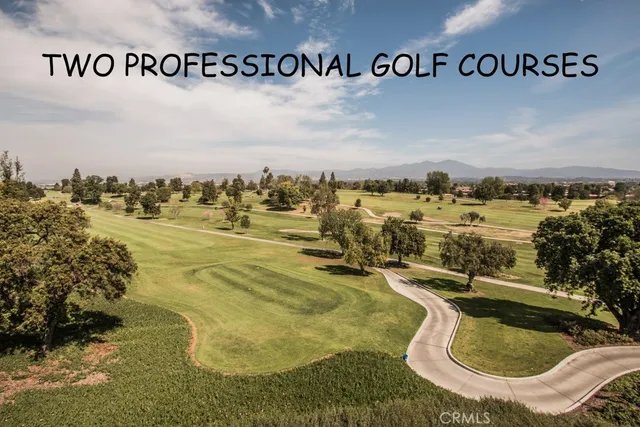a backyard of a house with barbeque oven table and chairs
