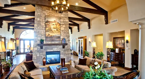 a living room with fireplace furniture and a potted plant