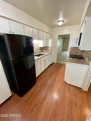 a kitchen with stainless steel appliances a refrigerator and a stove top oven