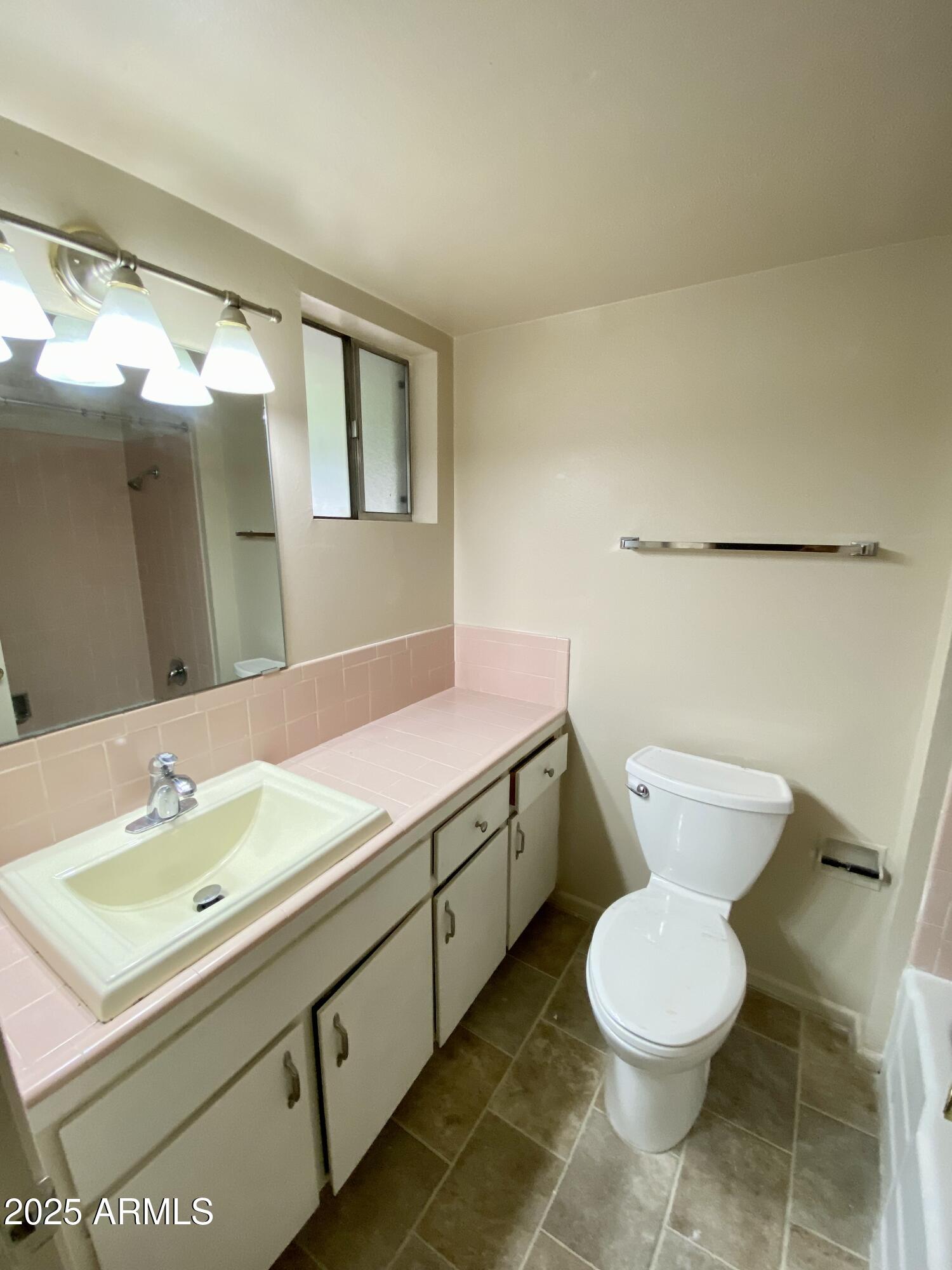 1107 West Osborn Road, Unit 113 Phoenix, AZ 85013 - Photo 11 of 20 a bathroom with a sink mirror vanity and toilet