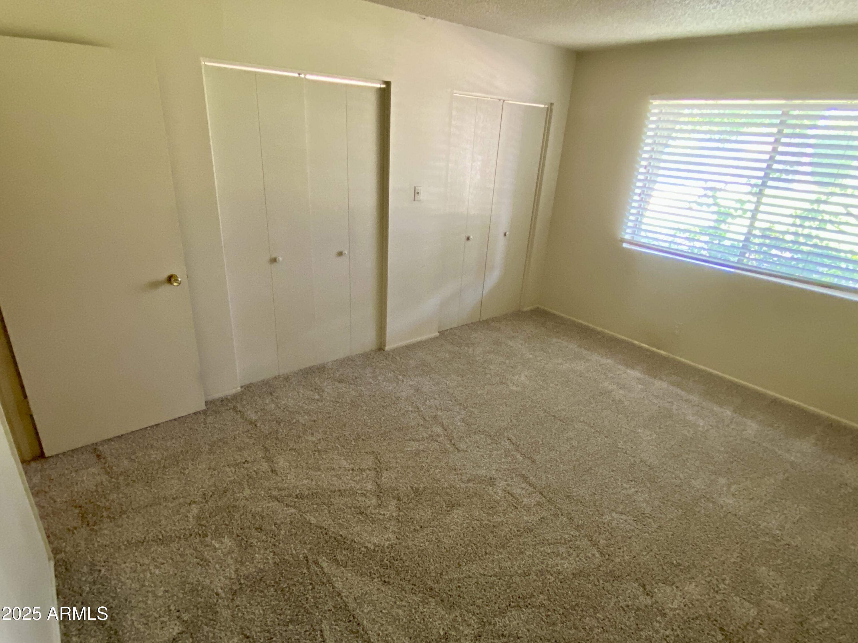 1107 West Osborn Road, Unit 113 Phoenix, AZ 85013 - Photo 15 of 20 a view of an empty room with a window