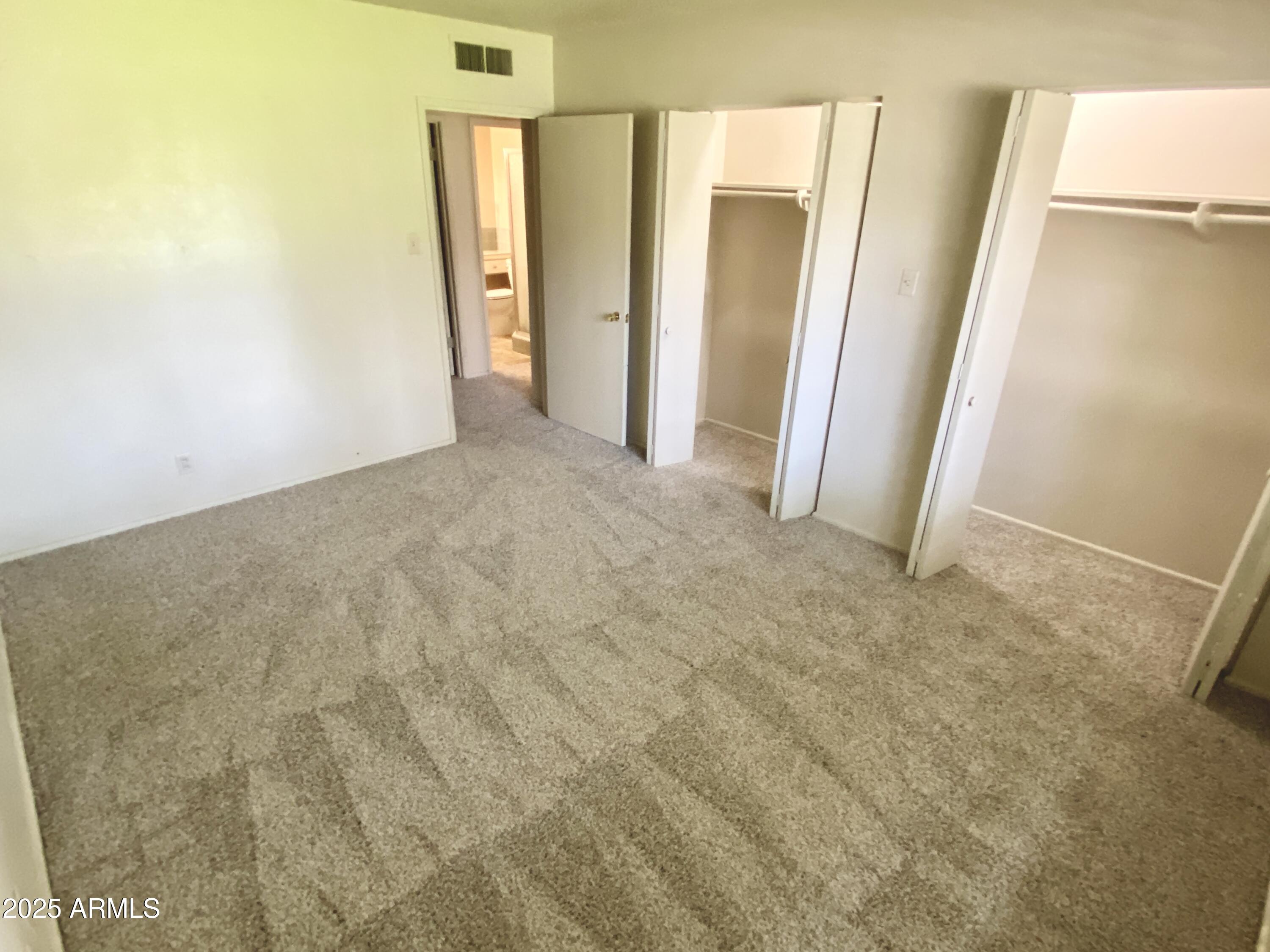 1107 West Osborn Road, Unit 113 Phoenix, AZ 85013 - Photo 16 of 20 an empty room with closet