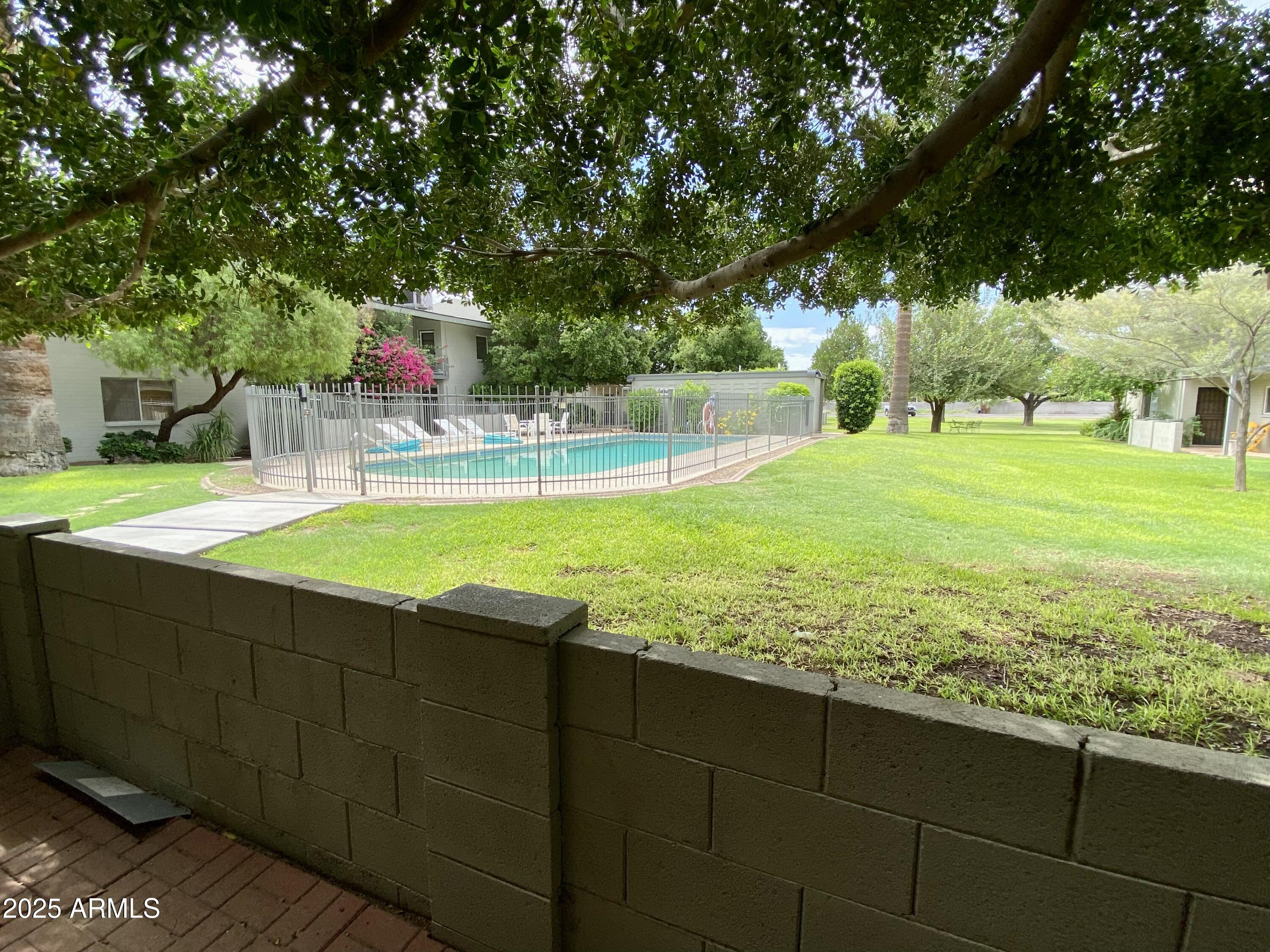 1107 West Osborn Road, Unit 113 Phoenix, AZ 85013 - Photo 19 of 20 a view of a swimming pool with a patio