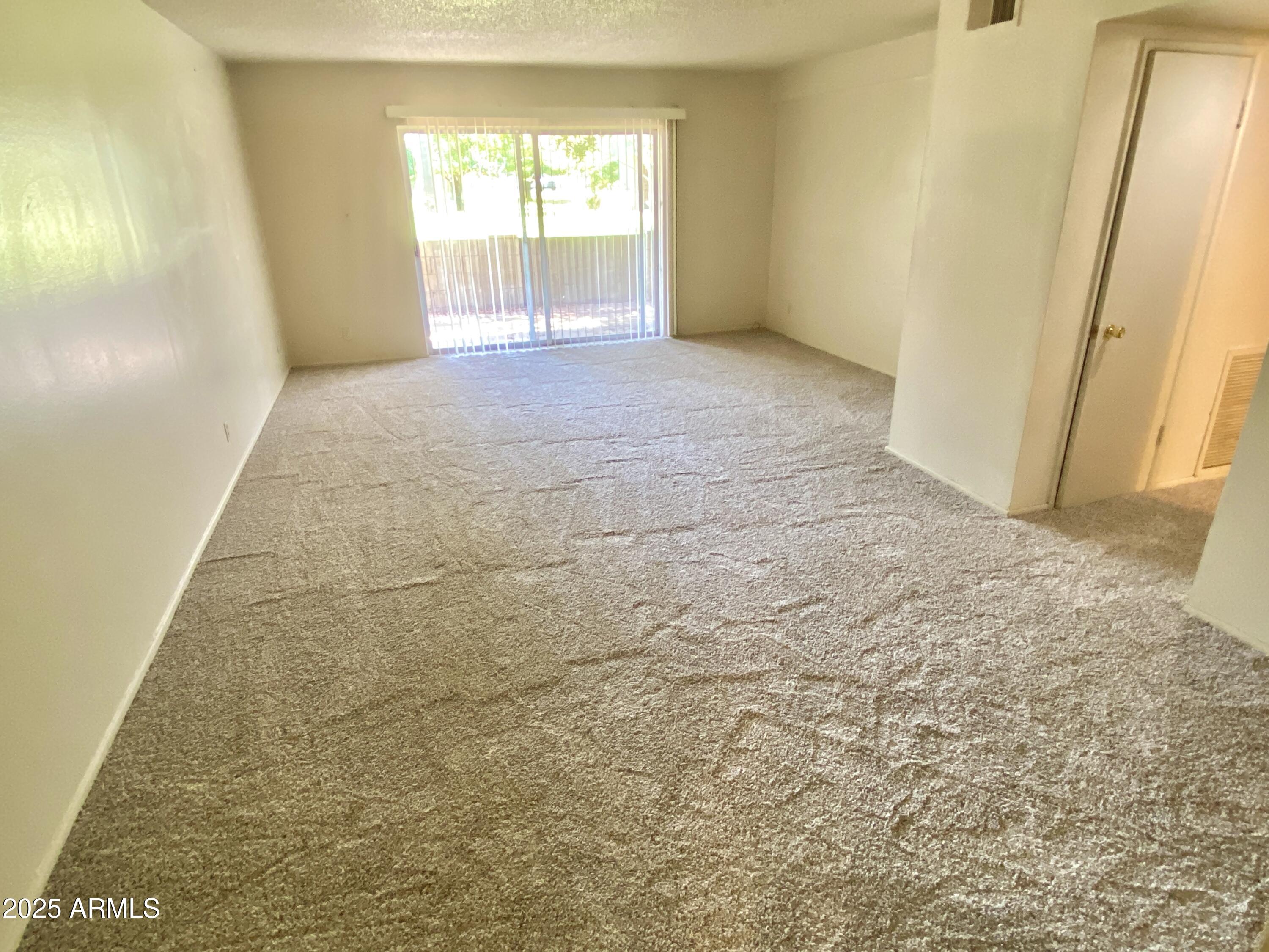 1107 West Osborn Road, Unit 113 Phoenix, AZ 85013 - Photo 5 of 20 an empty room with windows