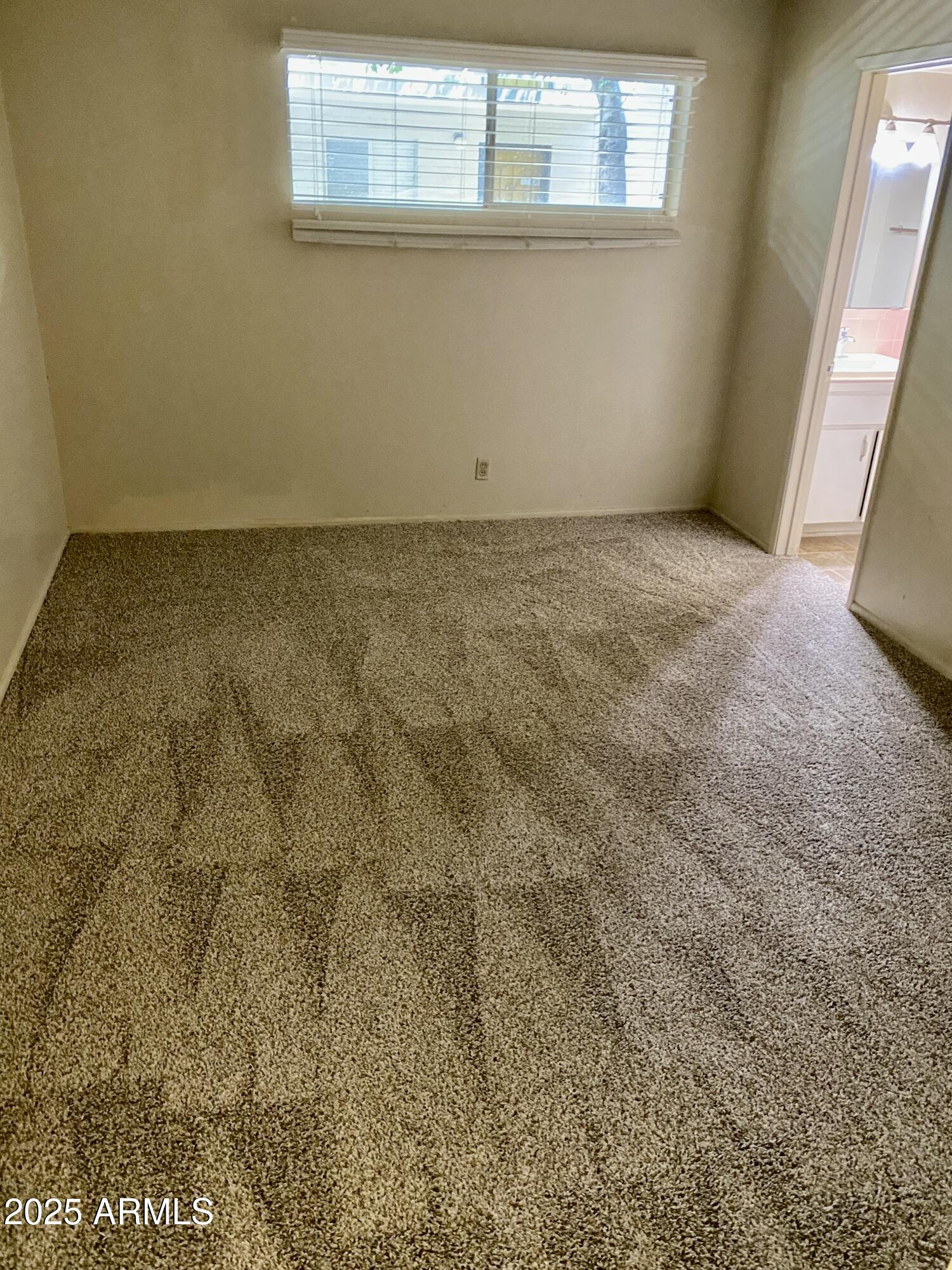 1107 West Osborn Road, Unit 113 Phoenix, AZ 85013 - Photo 7 of 20 an empty room with a window