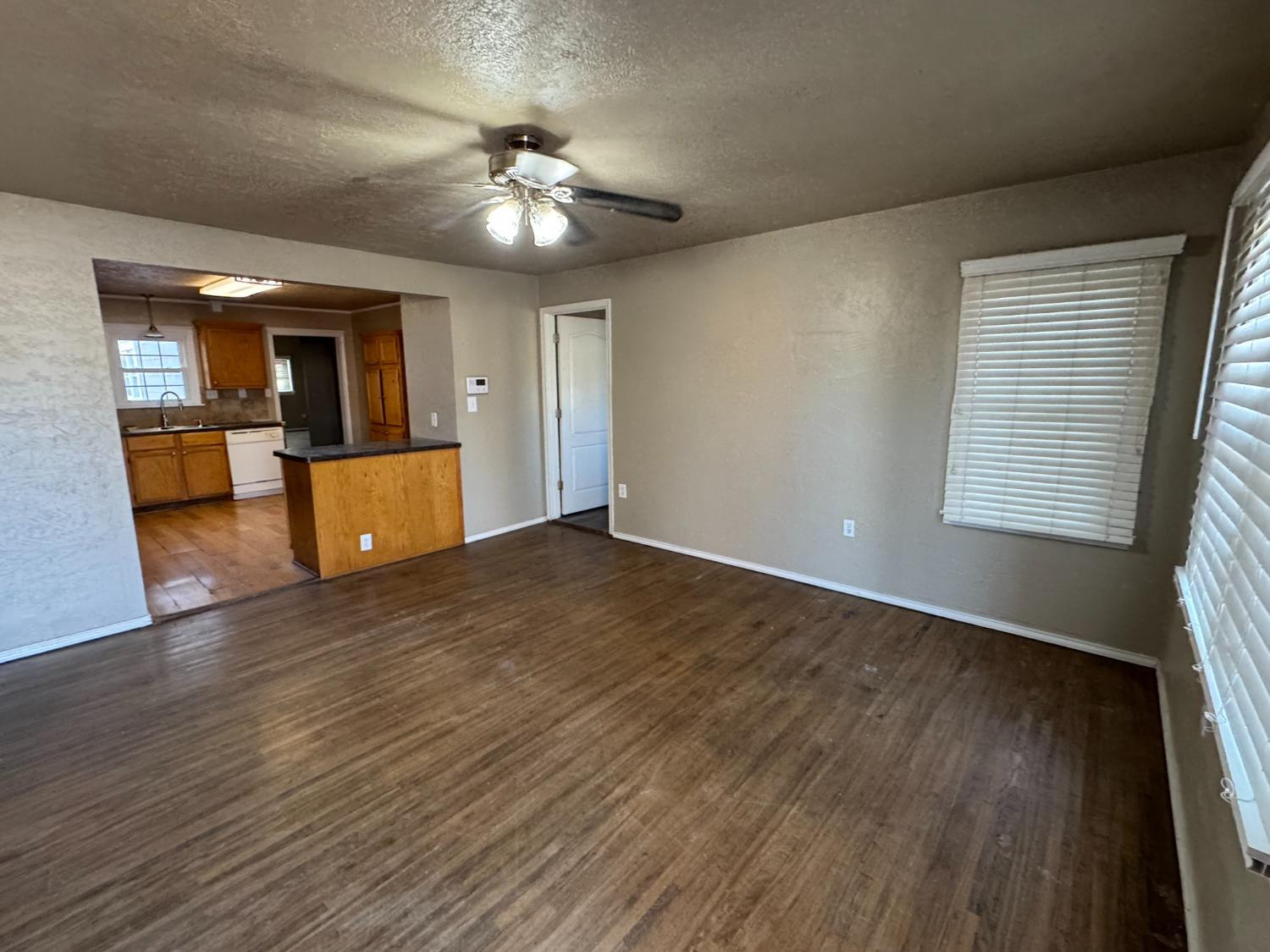 3111 30th Street Lubbock, TX 79410 - Photo 1 of 12 a view of a livingroom with furniture wooden floor and chandelier