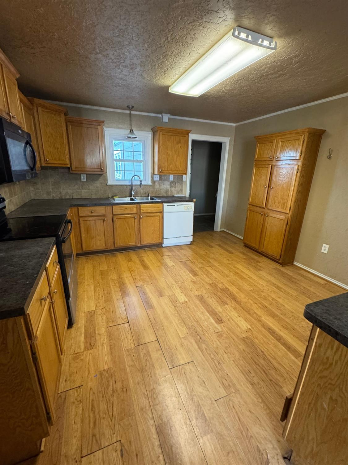 3111 30th Street Lubbock, TX 79410 - Photo 2 of 12 a bathroom with a sink a mirror and a bathtub