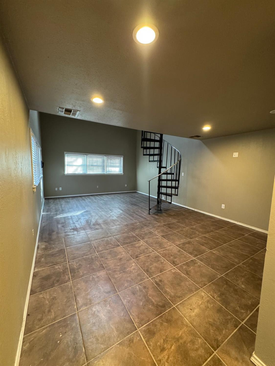 3111 30th Street Lubbock, TX 79410 - Photo 5 of 12 a view of an empty room with windows and fireplace