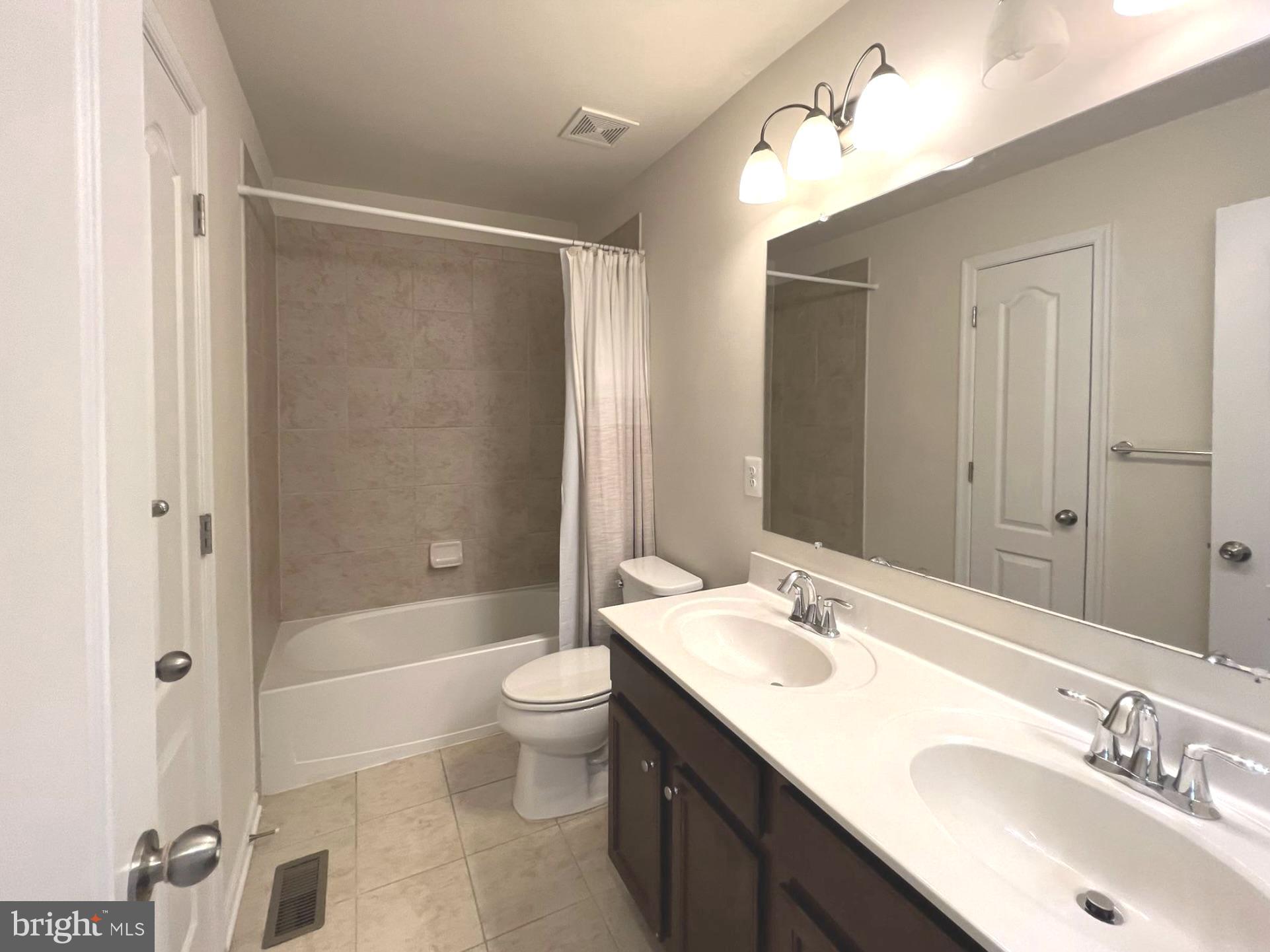 1009 Red Clover Road Gambrills, MD 21054 - Photo 15 of 21 a bathroom with a bathtub shower sink mirror and toilet