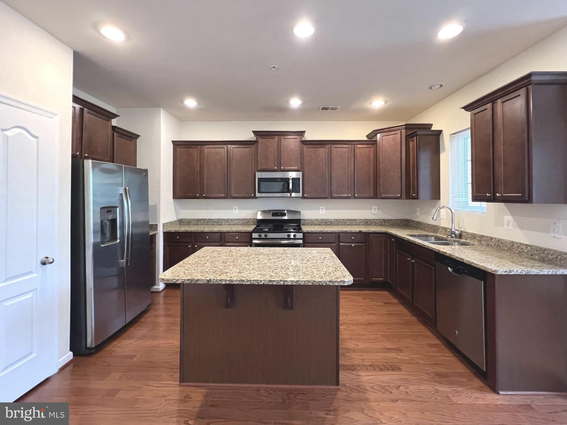 1009 Red Clover Road Gambrills, MD 21054 - Photo 6 of 21 a large kitchen with stainless steel appliances and a refrigerator