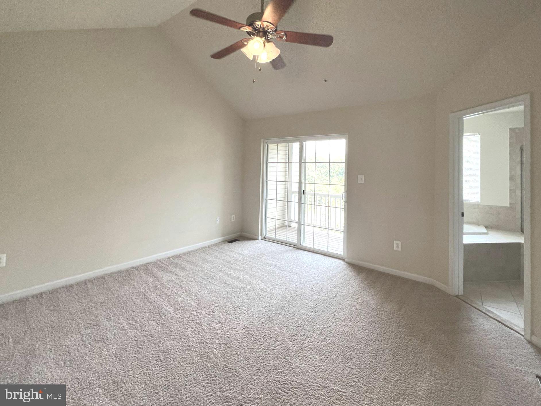 1009 Red Clover Road Gambrills, MD 21054 - Photo 8 of 21 an empty room with chandelier fan and windows