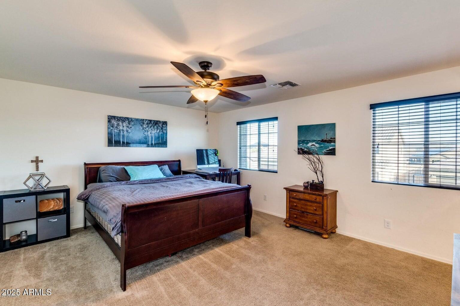 12057 West Rowel Road Peoria, AZ 85383 - Photo 14 of 20 a spacious bedroom with a bed and a chandelier
