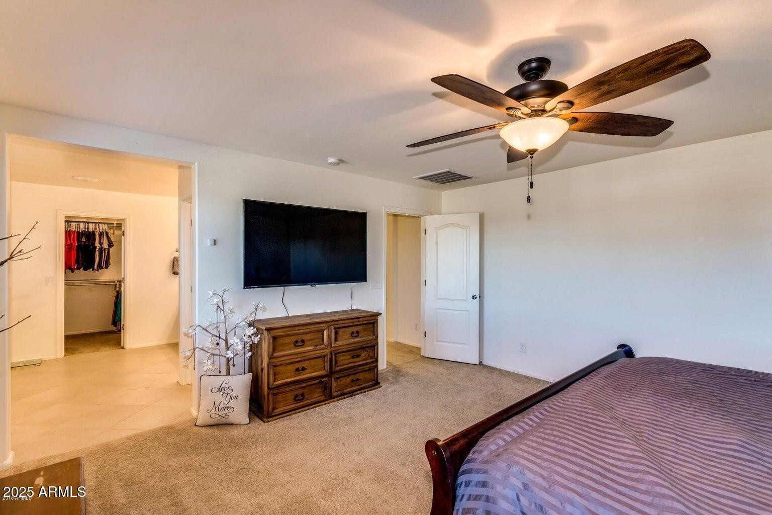 12057 West Rowel Road Peoria, AZ 85383 - Photo 15 of 20 a bedroom with a bed and a flat screen tv