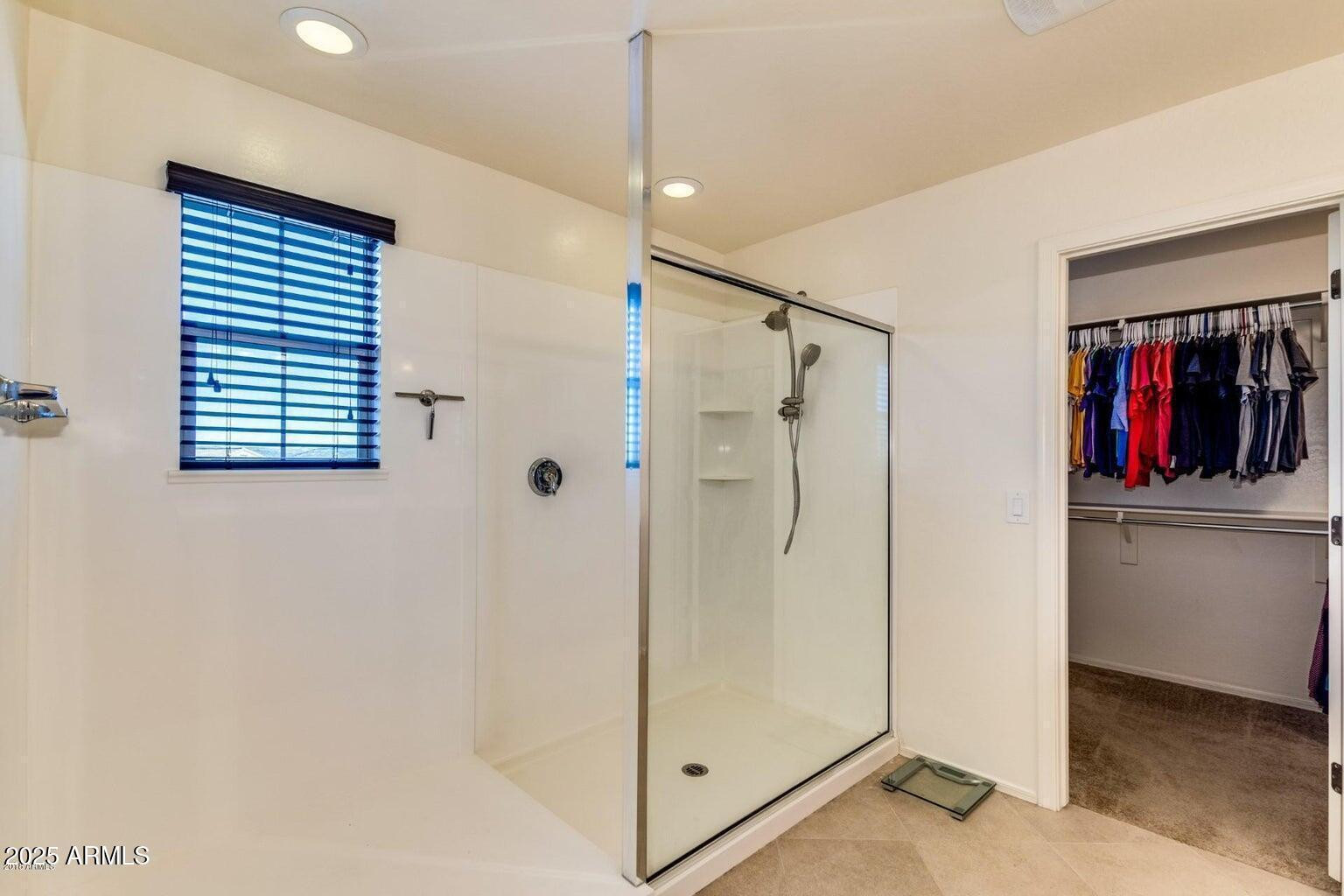 12057 West Rowel Road Peoria, AZ 85383 - Photo 16 of 20 a bathroom with a shower and a sink