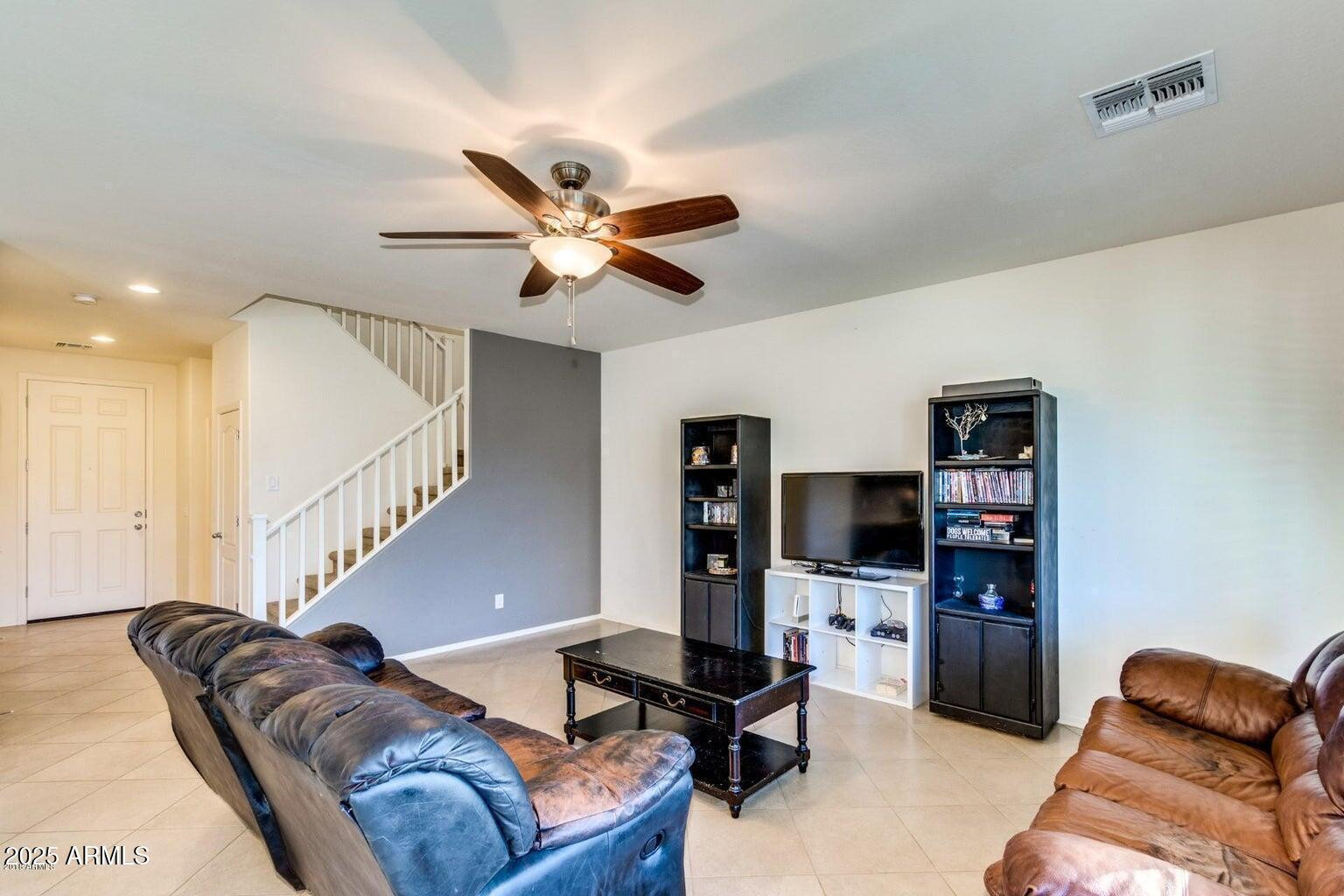 12057 West Rowel Road Peoria, AZ 85383 - Photo 3 of 20 a living room with furniture and a flat screen tv