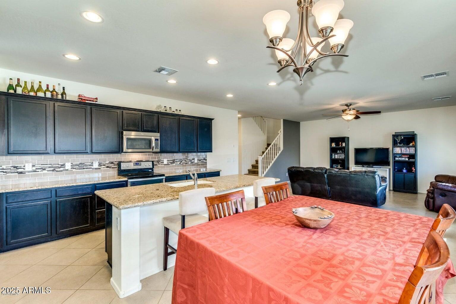 12057 West Rowel Road Peoria, AZ 85383 - Photo 6 of 20 a view of a dining room with furniture
