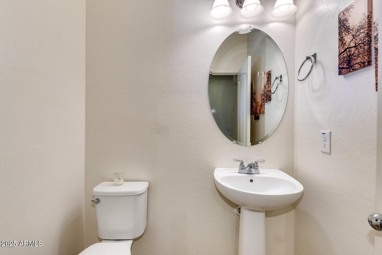12057 West Rowel Road Peoria, AZ 85383 - Photo 8 of 20 a bathroom with a toilet sink and mirror