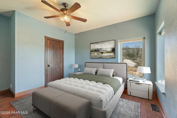 a bedroom with a large bed and a chandelier