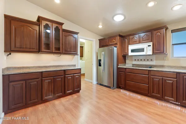 a kitchen with stainless steel appliances granite countertop a refrigerator and a sink