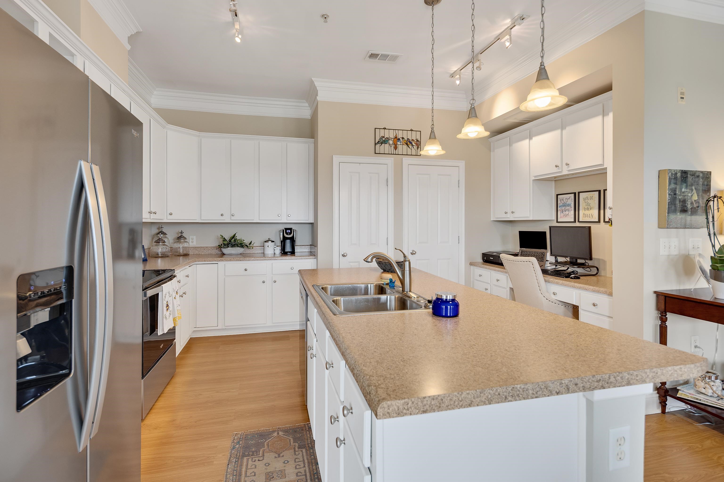 680 Harbor Bend Road, Unit 308 Memphis, TN 38103 - Photo 10 of 31 Kitchen featuring appliances with stainless steel finishes, track lighting, crown molding, light wood finished floors, and built in study area