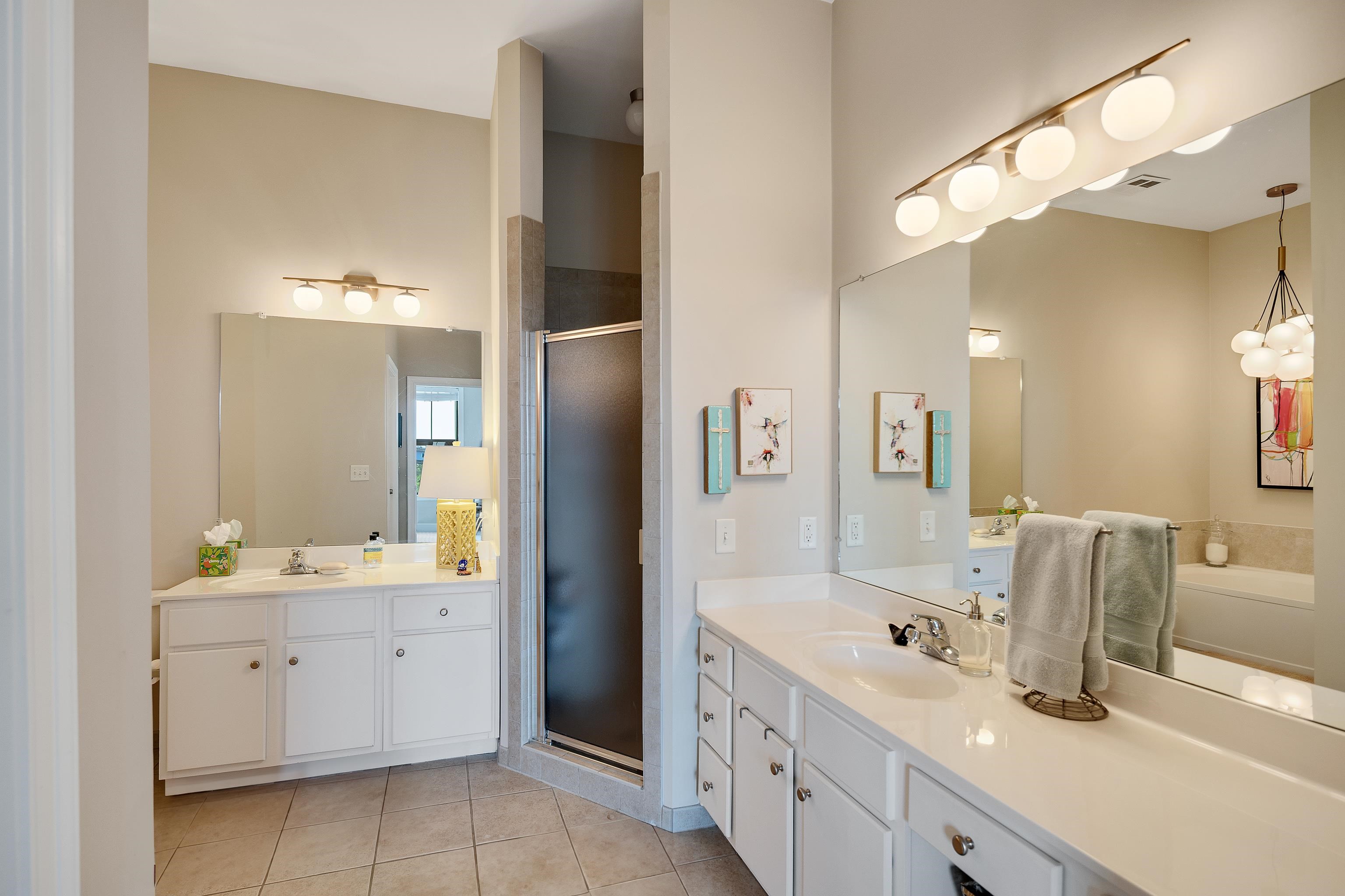 680 Harbor Bend Road, Unit 308 Memphis, TN 38103 - Photo 16 of 31 Bathroom featuring tile patterned floors, a shower stall, and two vanities