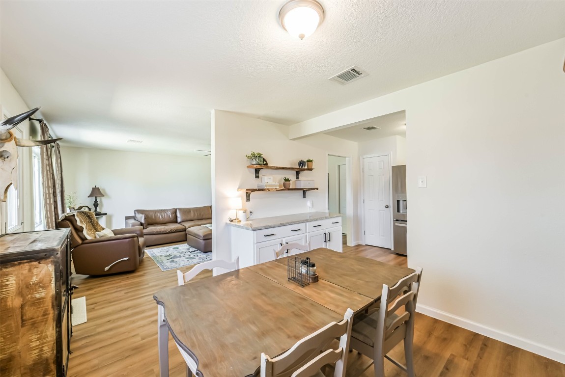 323 Coventry Lane Alvin, TX 77511 - Photo 15 of 37 a living room with stainless steel appliances furniture a rug and a kitchen view