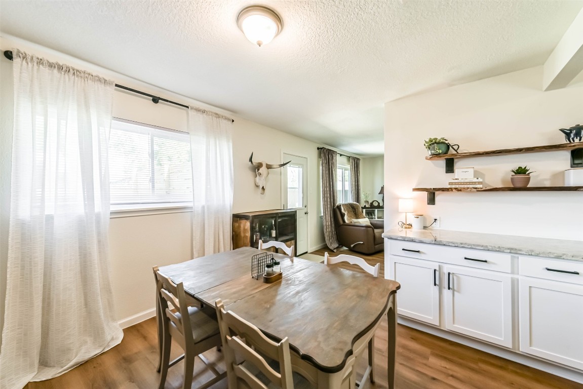 323 Coventry Lane Alvin, TX 77511 - Photo 16 of 37 a view of a kitchen area with furniture and wooden floor