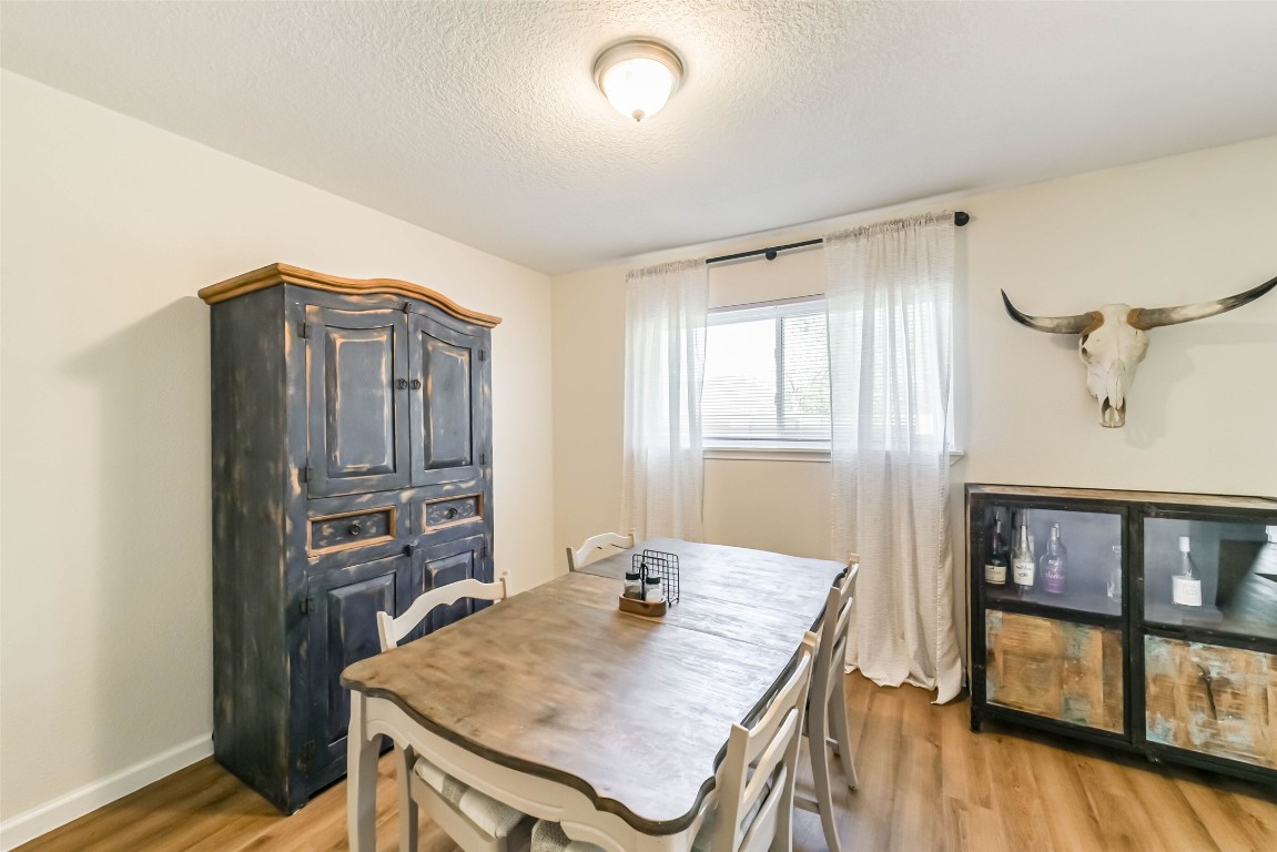 323 Coventry Lane Alvin, TX 77511 - Photo 17 of 37 a view of a dining room with furniture and wooden floor