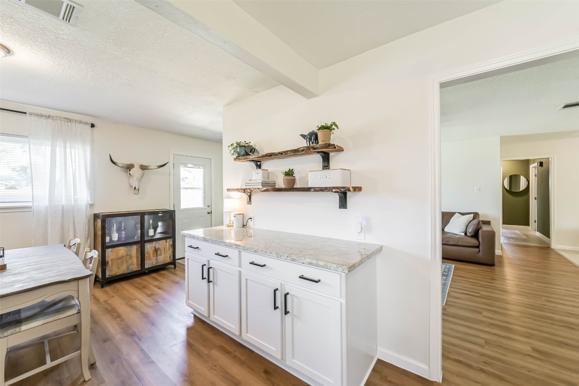 323 Coventry Lane Alvin, TX 77511 - Photo 18 of 37 a open kitchen with cabinets and wooden floor