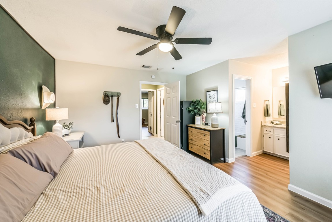 323 Coventry Lane Alvin, TX 77511 - Photo 22 of 37 a large bedroom with a bed and a flat screen tv