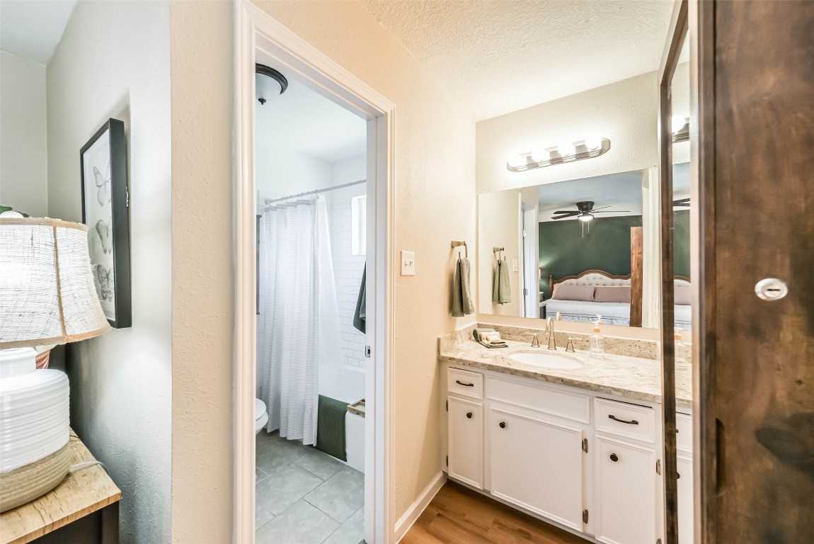 323 Coventry Lane Alvin, TX 77511 - Photo 23 of 37 a en suite bathroom with a granite countertop sink and a mirror