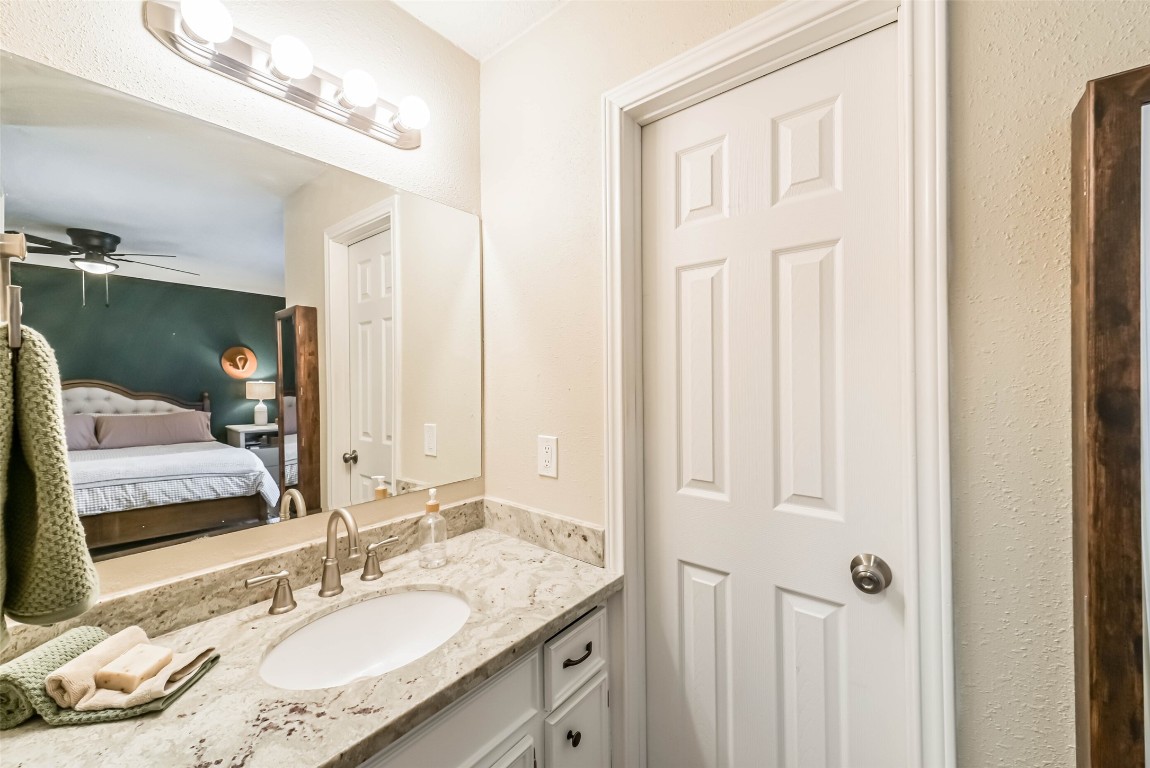 323 Coventry Lane Alvin, TX 77511 - Photo 25 of 37 a bathroom with a granite countertop sink and a mirror