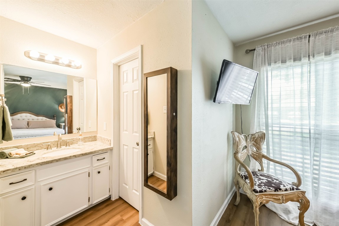 323 Coventry Lane Alvin, TX 77511 - Photo 26 of 37 a bathroom with a granite countertop sink and a mirror