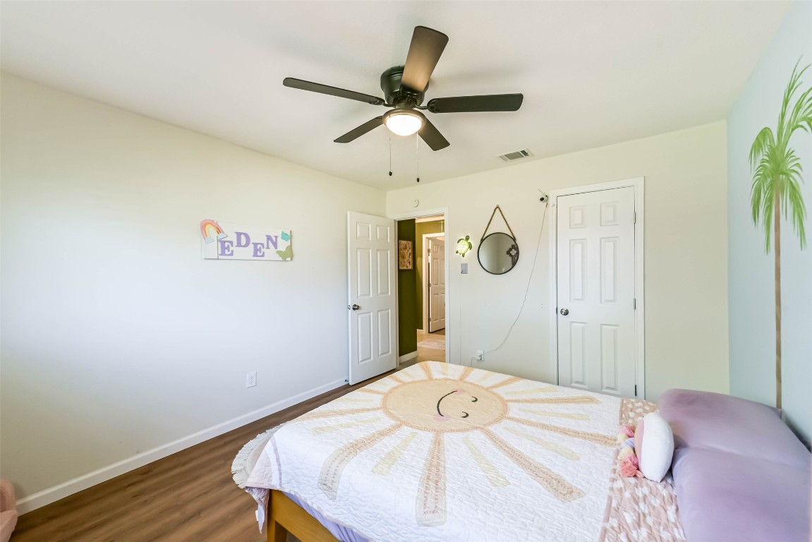 323 Coventry Lane Alvin, TX 77511 - Photo 28 of 37 a bedroom with a bed and a chandelier