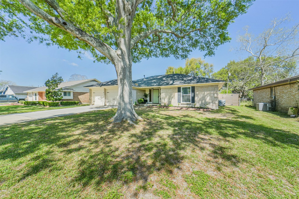 323 Coventry Lane Alvin, TX 77511 - Photo 3 of 37 a front view of a house with a garden